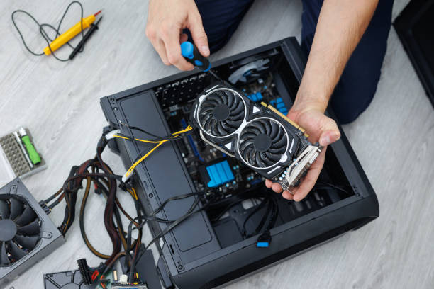 istock Man is holding a computer video card in his hands. Computer maintenance. 2104004316