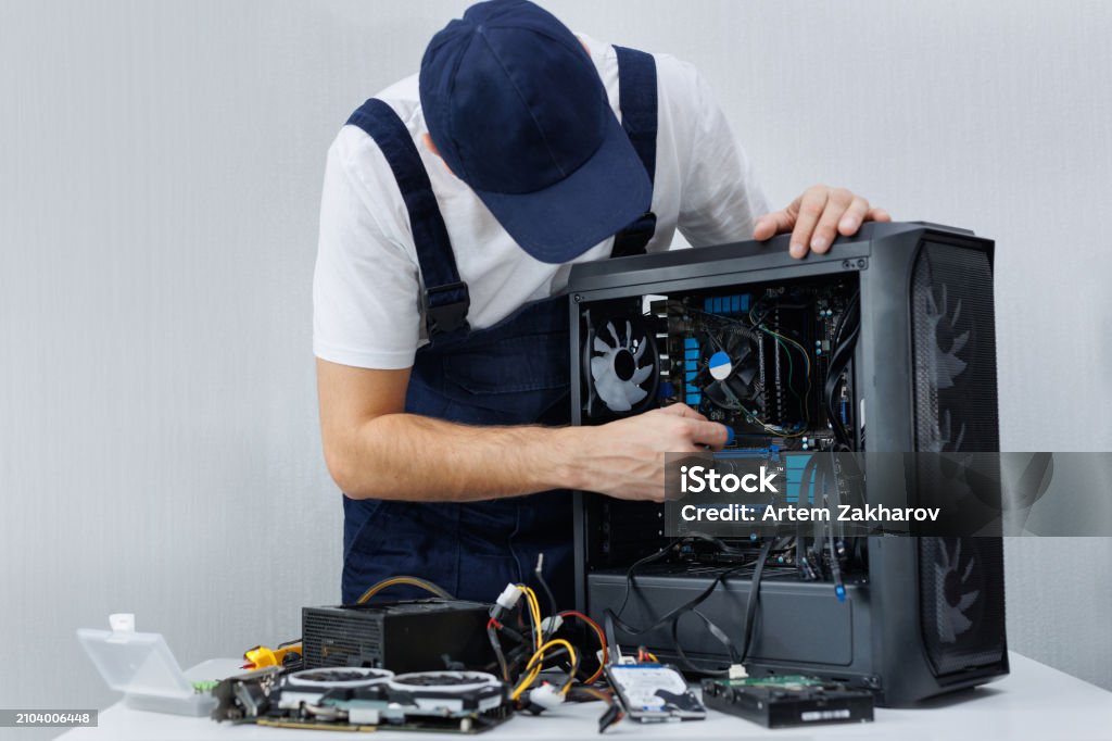 A Computer Engineer Uniform A Computer Engineer In Uniform Repairs A Personal Computer Stock Photo ...