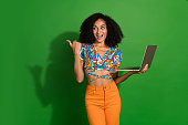 Photo of young excited positive girl holding macbook pro 15 point finger empty space download update ios isolated on green color background