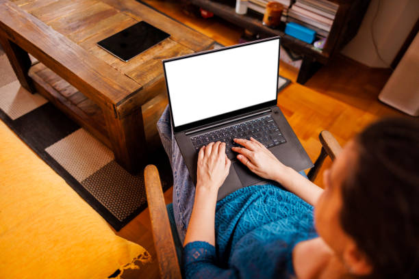 istock Laptop with white screen holds woman in sofa 2104020331