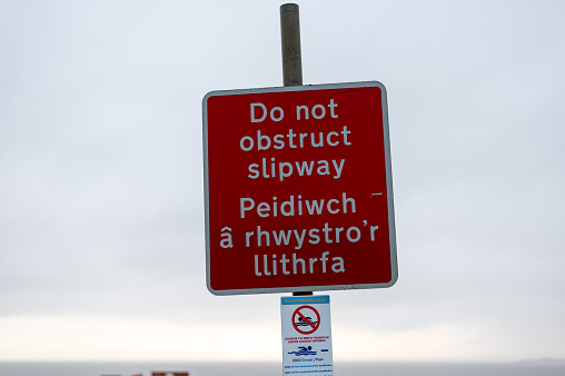 Warning sign near a beach in Wales advising against obstructing a slipway