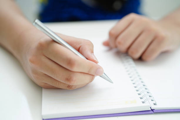 istock Asian teenage student write homework, study lesson for exam online learning education. 2104028736