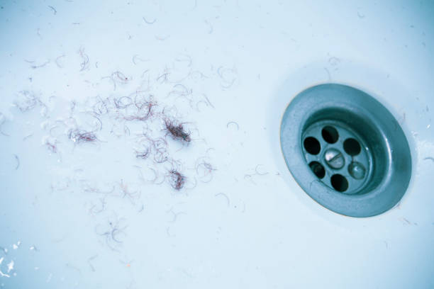 shaved hair from the intimate areas of the pubic area after shaving and depilation remaining on the walls of the bathroom sink, close-up texture - rust covered imagens e fotografias de stock