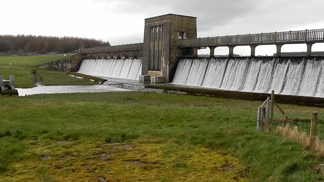 Llyn Cefni reservoir overflowing from Llangefni lagoon dam water in the Anglesey countryside