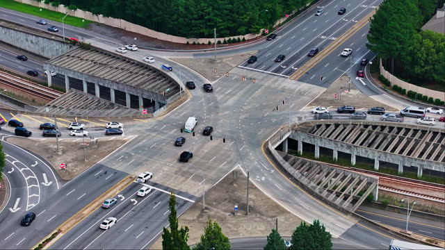 Aerial top down of busy multi lane junction and tracks underpass in American Town.