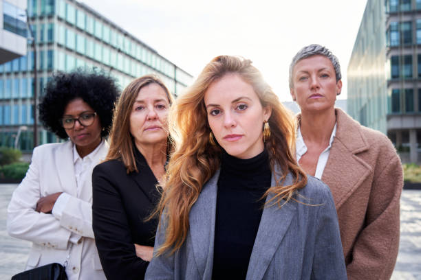 Four empowered multiracial business women looking at camera confidence.