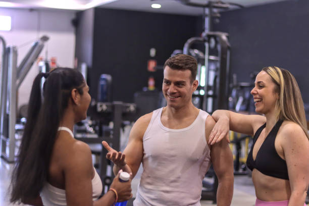 istock Group of multiracial smiling people talking to each other inside a gym 2104053834