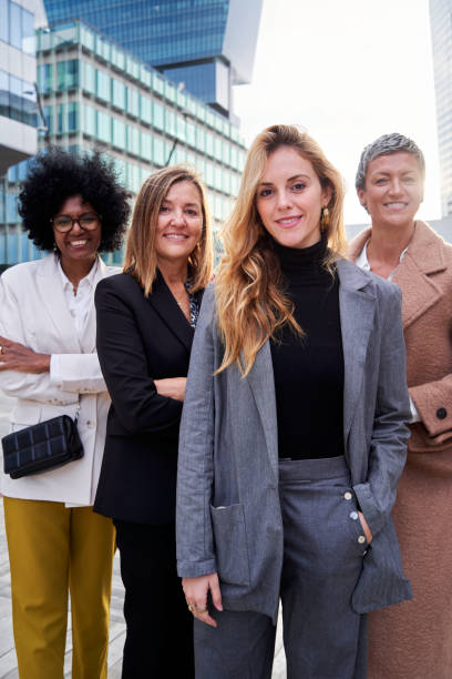 istock Four confident multiethnic business women looking at camera smiling. 2104076337