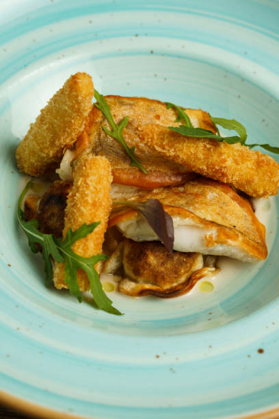 istock Fried fish with baby corn in a plate on wooden table 2104086380