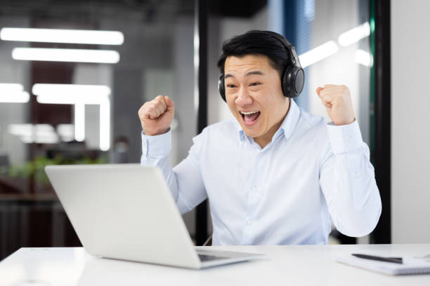 istock Excited businessman celebrating success at work 2104099311