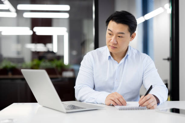 istock Professional man working at a modern office desk 2104101379