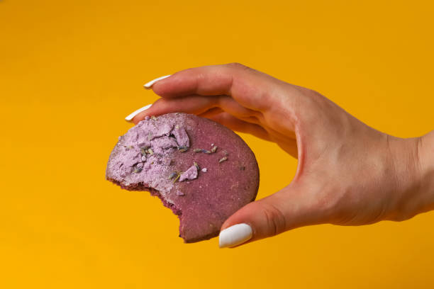 istock Lavender cookies in a woman's hand. Close-up 2104121877