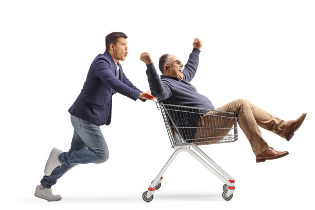 istock Man pushing his mature father inside a shopping cart 2104123467