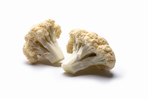 Fresh cauliflower cabbage pieces isolated on a white background. Studio shot: