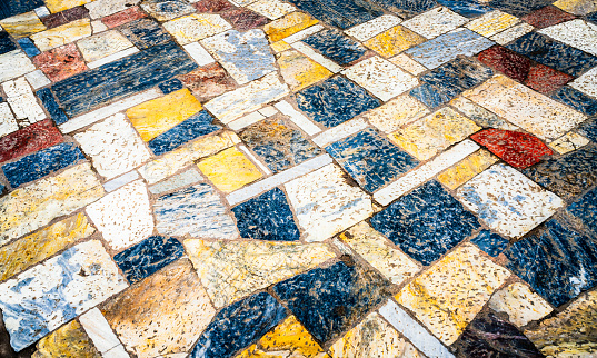Heavy weathering on the surface of a large outdoor area of marble flooring near to the Acropolis in Athens, Greece.