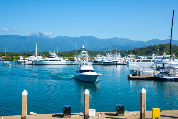 Horizontal landscape photo of a boat moored at the jetty on the river, Port Douglas, far north Queensland