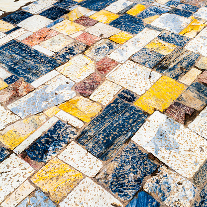 The surface of a large area of outdoor marble flooring in ancient Athens, Greece.