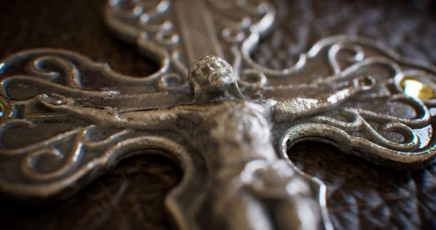 The luxurious leather cover of a Bible shines with a radiant silver cross, its elaborate details reflecting light and casting a celestial brilliance