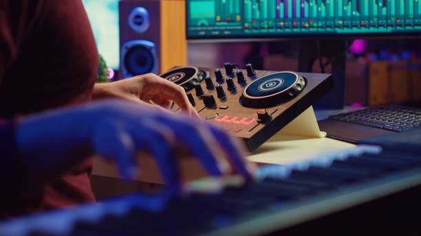 istock Skilled artist playing piano keyboard and recording sounds on daw software 2104147859
