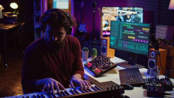 istock Musician producing new high quality piano tunes with daw software 2104148431