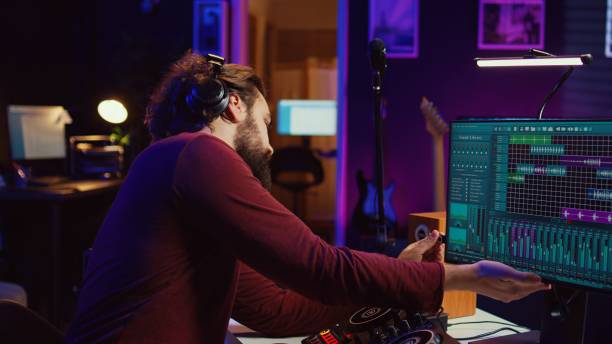 istock Audio engineer inserting an usb stick in the pc to record himself playing piano 2104150532