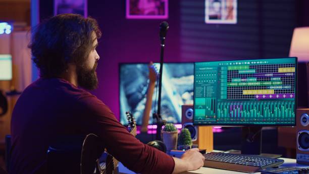 istock Music producer operating with electronic setup of home studio 2104155869