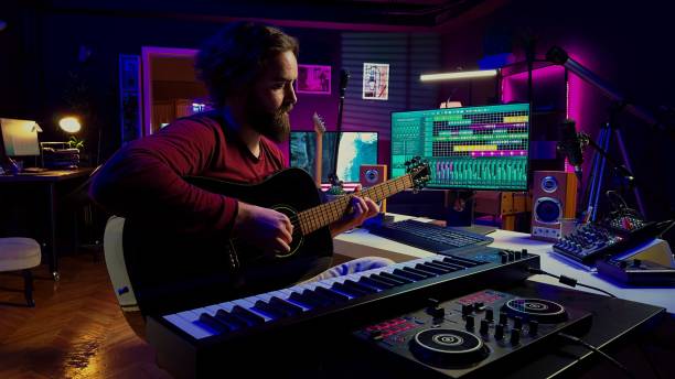 istock Music engineer practices acoustic guitar and writes songs 2104156415