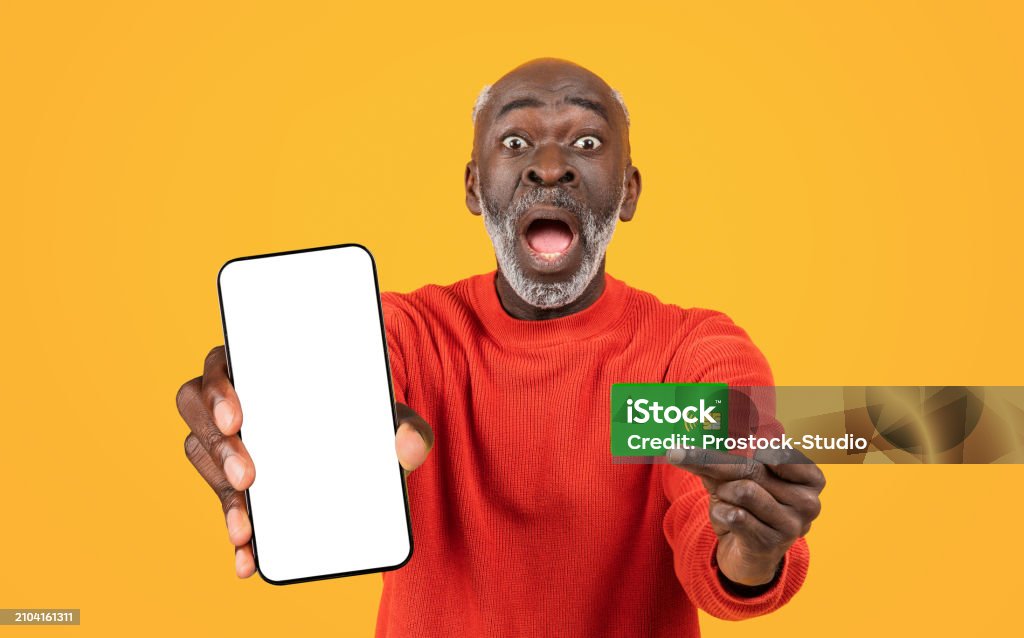 Shocked Funny Old Black Man With Open Mouth Show Credit Card And Phone shocked-funny-old-black-man-with-open-mouth-show-credit-card-and-phone