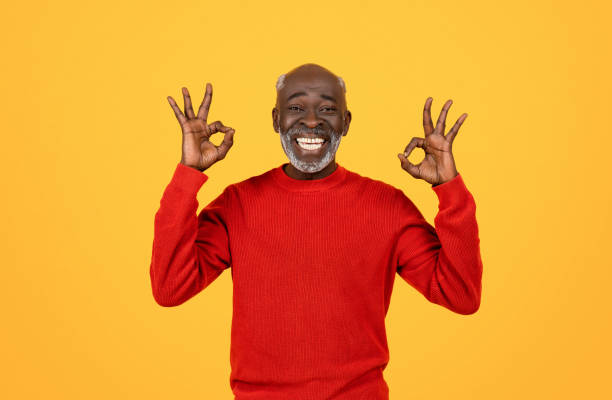 istock Cheerful senior Black man with white beard making the 'OK' sign with both hands 2104161328