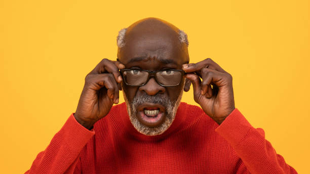 istock Surprised senior Black man adjusting his glasses with a puzzled expression 2104161351