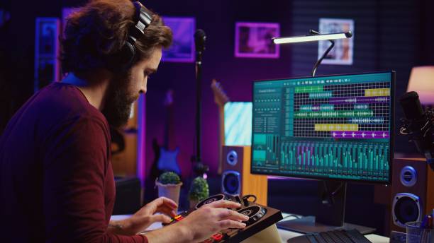istock Music producer recording piano keyboard notes and editing on a mixing console 2104164635