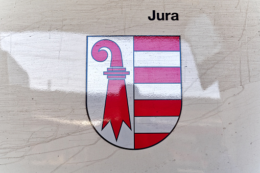Coat of arms of Swiss Canton Jura outside of train at railway station of Venezia Santa Lucia on a sunny summer afternoon. Photo taken August 11th, 2023, Venice, Italy.