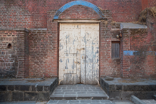 European old house exterior, brick wall and wooden door