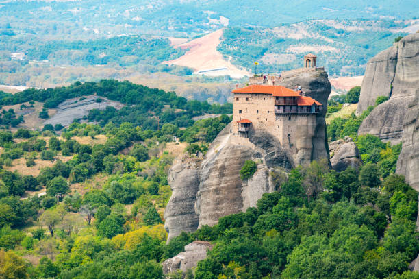 istock Monastery Meteora Greece. Stunning summer panoramic landscape. View at mountains and green forest against epic blue sky with clouds. UNESCO heritage list object. 2104194877