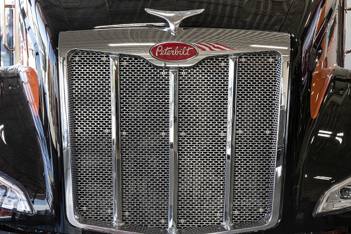 Indianapolis - March 20, 2024: Peterbilt Semi Tractor Trailer Trucks logo and truck grille. Peterbilt is owned by PACCAR Trucks.