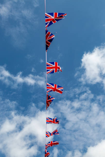 istock Looking up at Union Jack bunting against a blue sky 2104221514