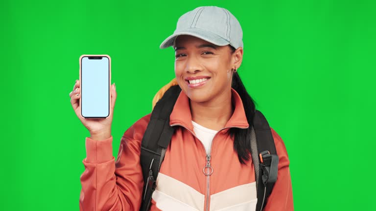 Student woman, phone and green screen with face, smile and nod in agreement, review and mockup space. Girl, blank smartphone and mock up for logo, branding or ux for mobile app, backpack and travel