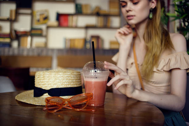 pretty woman sitting at a table with a drink in a cafe communication. High quality photo