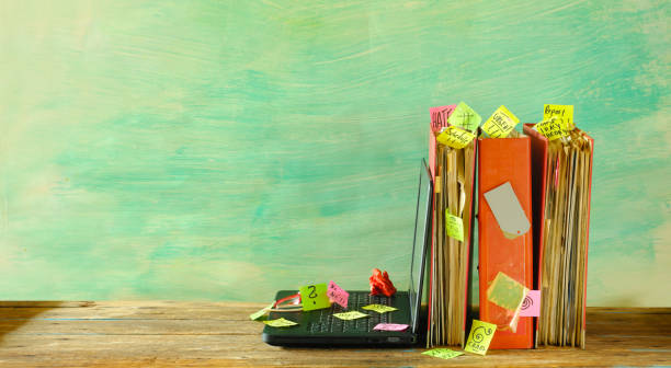 istock messy file folders and laptop computer, red tape, bureaucracy,aministration,overworked, home office and business concept,free copy space. 2104348883