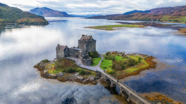 Dornie, Kyle Of Lochalsh Scotland: october 9th of 2023 - Eilean Donan Castle is a picturesque and iconic Scottish landmark, located on a small tidal island at the point where three sea lochs meet in the western Highlands of Scotland. The castle is recognized around the world and is one of the most visited and important attractions in the Scottish Highlands. The castle history is quite dramatic; it was partially destroyed in a Jacobite uprising in 1719 and lay in ruins for about 200 years. It was then restored to its former glory by Lieutenant Colonel John MacRae-Gilstrap, with the restoration completed in 1932