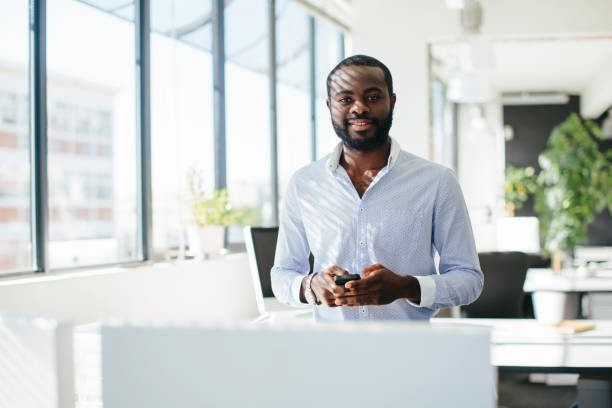istock Businessman Standing in a Bright Modern Office 2104375528
