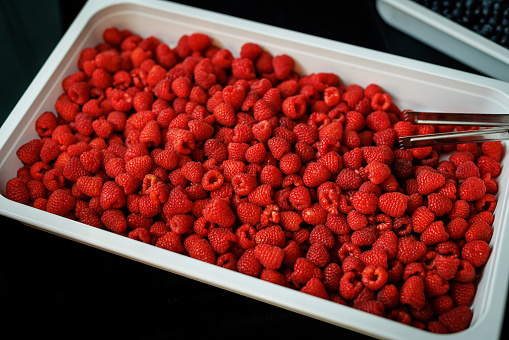 Raspberries in a white basket, top view