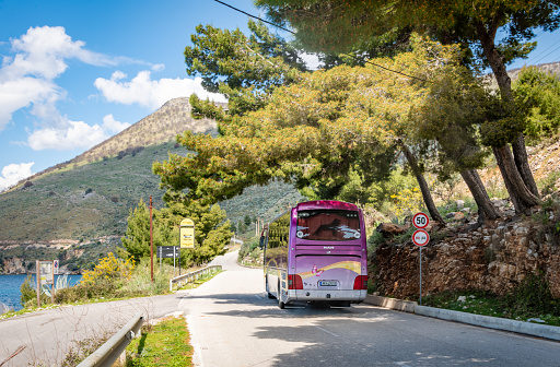 Saranda, Albania. 17 March 2024. Coach travels along the SH8 road on the Albanian Riviera.
