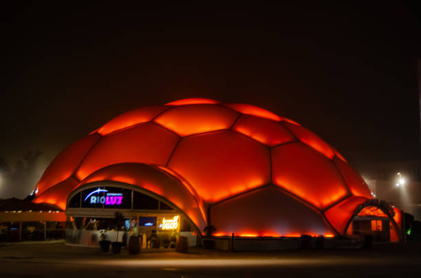 Modern illuminated building showing off color at night in a plaza in Valladolid, December 27, 2023.