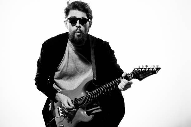 istock man with guitar in hands musician rock star performance lifestyle light background 2104438270