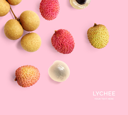 Creative layout made of lychee on the pink background. Flat lay. Food concept. Macro  concept.