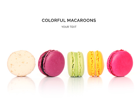 Creative layout made of colorful macaroons on the white background. Flat lay. Food concept.
