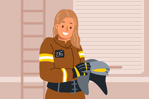 Woman firefighter holds helmet in hands, standing near rescue van and preparing to go out to extinguish fire. Young girl firefighter smiles and looks at camera, getting to fight flames