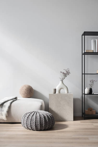 Interior design. Hassock, coffee table and bookshelf in a living room