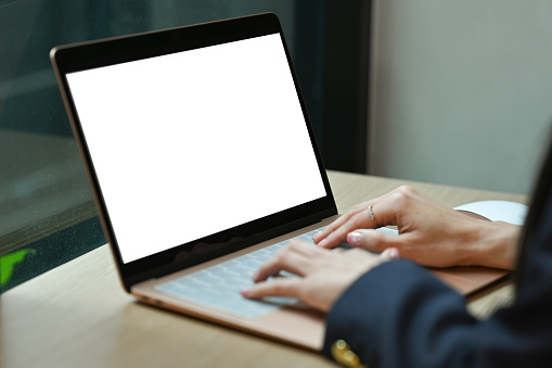 Close up and cropped image of Businesswoman using laptop, Empty screen of laptop.